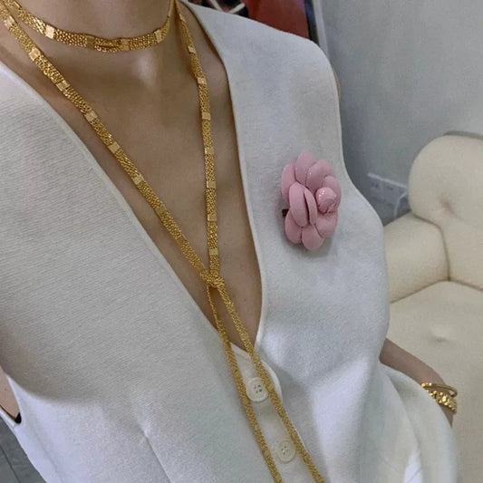 Lange, mehrlagige Halskette mit goldenen, quadratischen Quasten